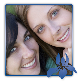 stock photo two young women huddled together smiling